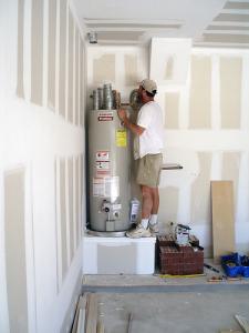 a new water ehater being installed in a garage area