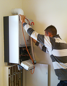 a Lakewood tech checks the temperature rise on a tankless water heater